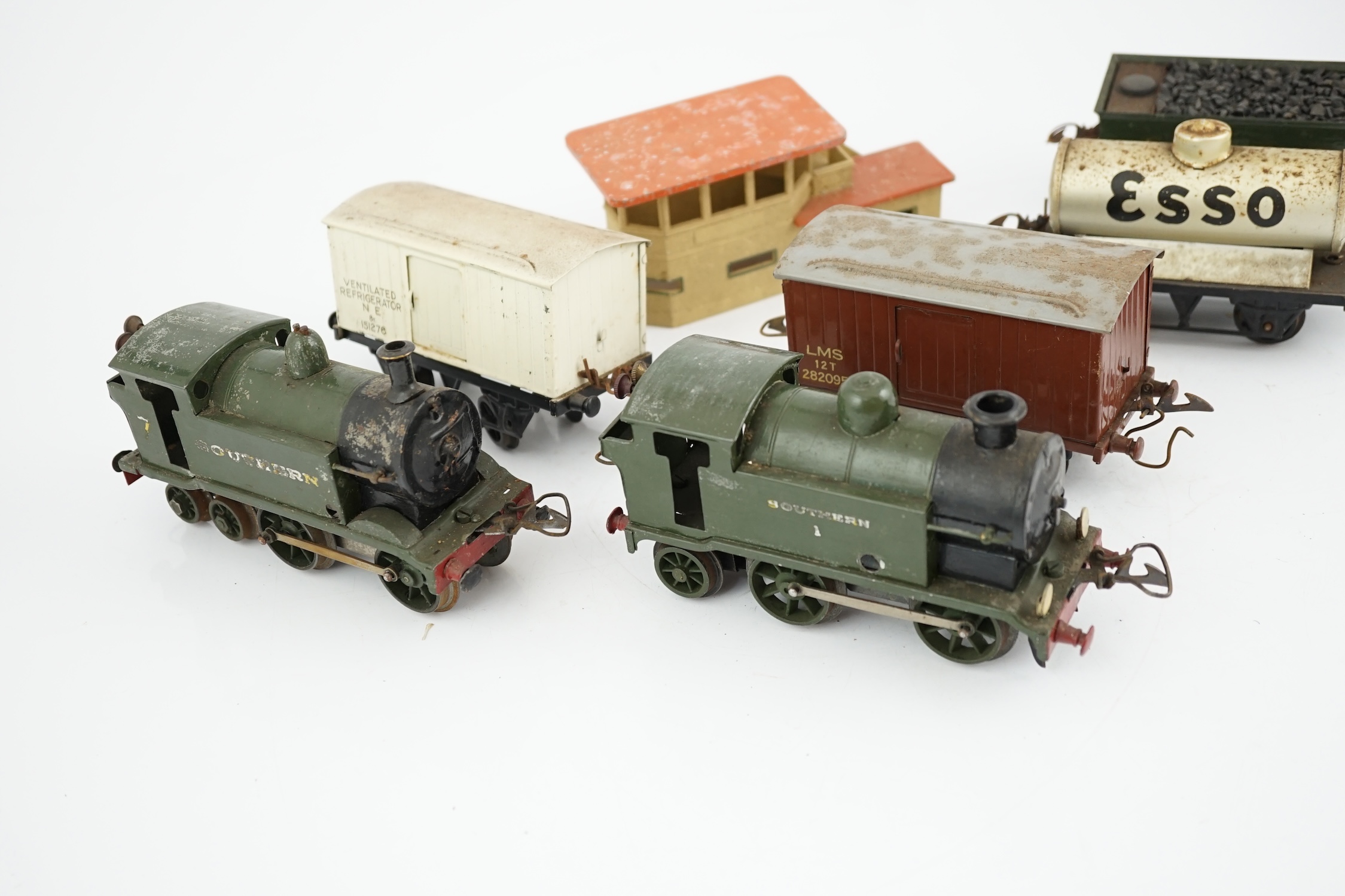 Fourteen 0 gauge tinplate etc. railway items, including three clockwork locomotives; an LSWR 4-4-0 tender loco, an SR 0-4-4T loco and an SR 0-4-2T loco, together with nine Hornby freight wagons, a Bing milk traffic van a